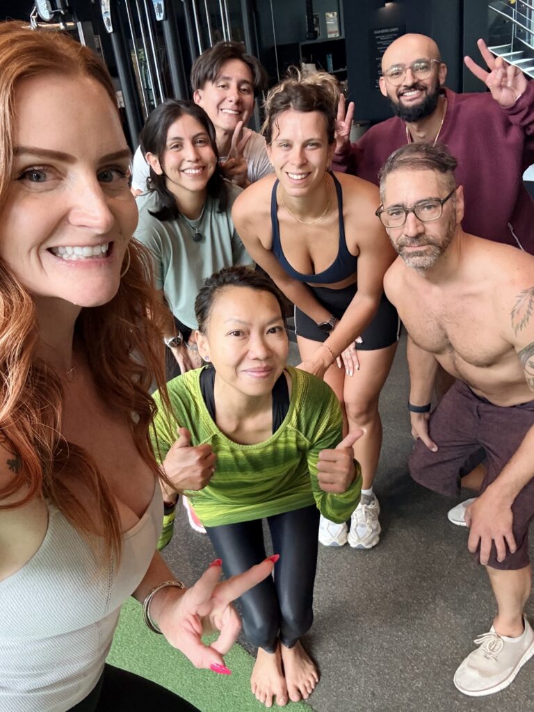 Residents and their Divine Fitness coach together after a community class