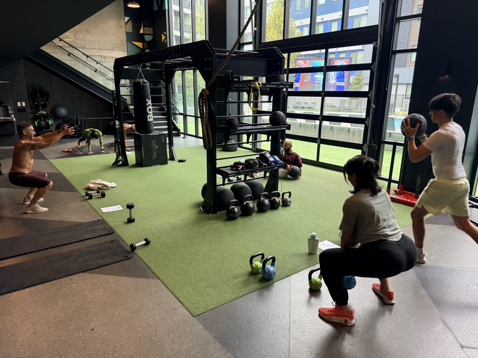 A coach-led group class using the turf, kettlebells and medicine balls in a Reno apartment community's fitness center